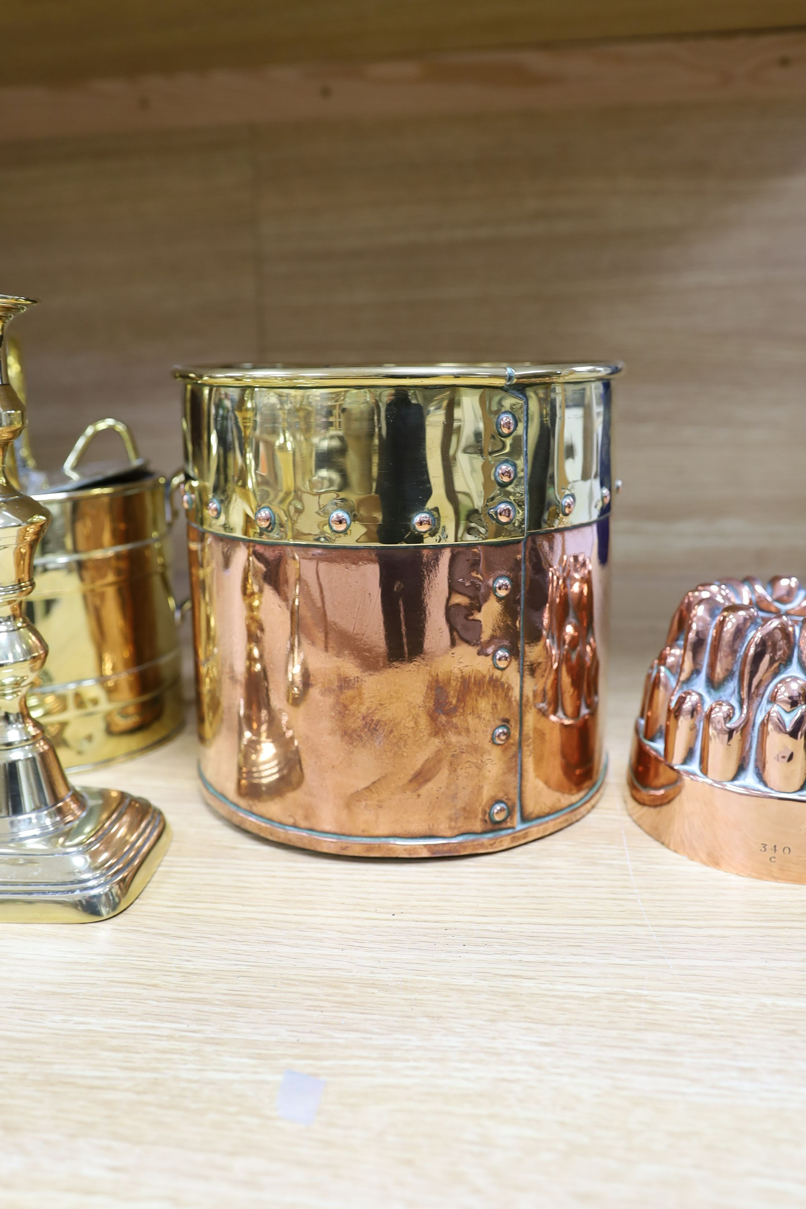 A Victorian copper jelly mould, pair of Victorian brass candlesticks 23cm, a brass water kettle, and a brass copper jardinière